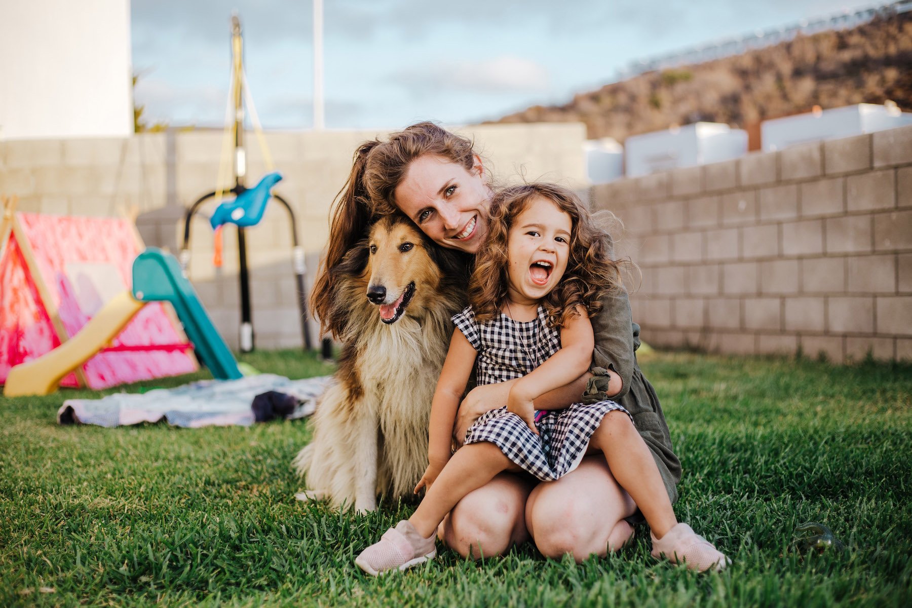 lady and kid and dog top turf-unsplash