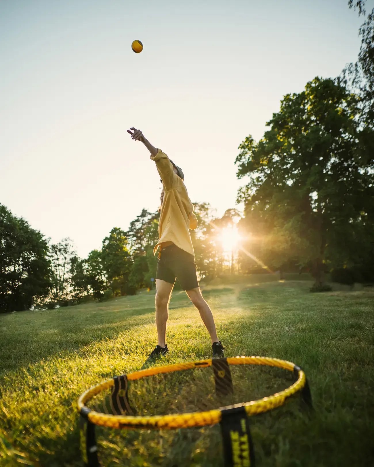 spikeball in back yard playing summer sunset unsplash